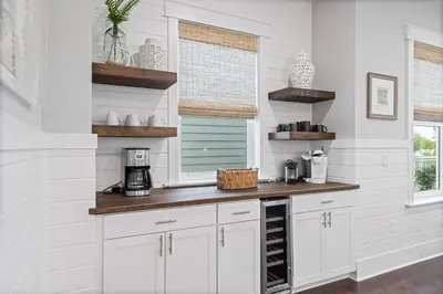 a white kitchen with a counter and a window at Seagrove Sunshine in Seagrove Beach