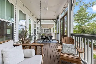 a porch with a couch and chairs on a house at Seagrove Sunshine in Seagrove Beach
