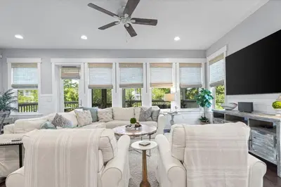 a living room with white furniture and a ceiling fan at Seagrove Sunshine in Seagrove Beach