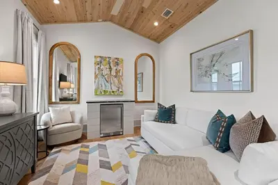 a living room with a white couch and a fireplace at Coastal Charm in Inlet Beach