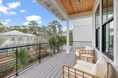 a porch with chairs and a balcony with a view at Coastal Charm in Inlet Beach