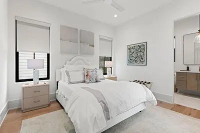 a white bedroom with a white bed and a window at Coastal Charm in Inlet Beach