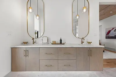 a bathroom with a sink and two mirrors at Coastal Charm in Inlet Beach