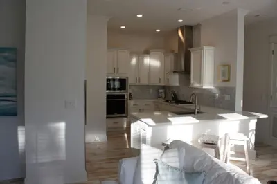 a kitchen with white cabinets and a white couch at BIG EASY on 30A in Watersound Beach