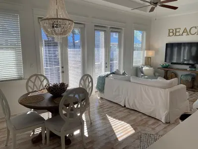 a living room with a couch and a table and chairs at BIG EASY on 30A in Watersound Beach