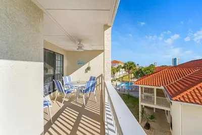 a balcony of a house with a table and chairs at Balconies with a View at Horizon South 54-302 in Panama City Beach