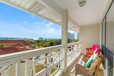 a balcony with a chair and a view of the city at Balconies with a View at Horizon South 54-302 in Panama City Beach