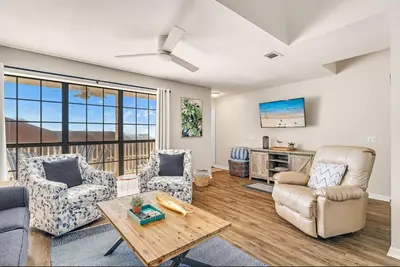 a living room with two chairs and a table at Balconies with a View at Horizon South 54-302 in Panama City Beach