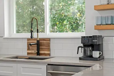 a kitchen with a sink and a coffee maker at Casa Del Palms - Private Pool Home, Game Room, 2 Min Walk to Beach, Pets OK! in Panama City Beach