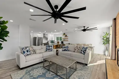 a living room with two couches and a ceiling fan at Casa Del Palms - Private Pool Home, Game Room, 2 Min Walk to Beach, Pets OK! in Panama City Beach