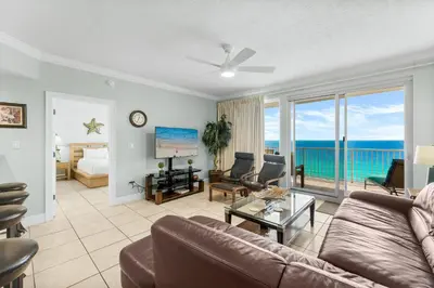 a living room with a couch and a view of the ocean at Treasure Island #1102 in Panama City Beach