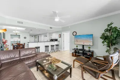 a living room with a couch and a table at Treasure Island #1102 in Panama City Beach