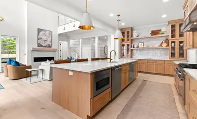 a kitchen with wooden cabinets and a large kitchen island at Something Salty in Santa Rosa Beach
