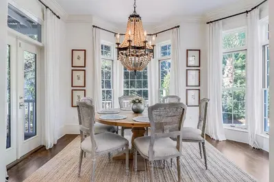a dining room with a table and chairs and a chandelier at Southern Breeze in Inlet Beach