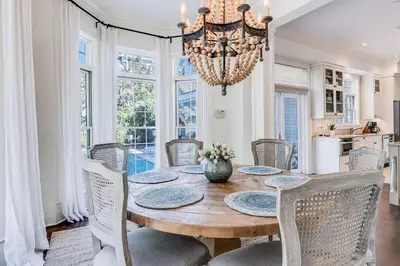 a dining room with a table with chairs and a chandelier at Southern Breeze in Inlet Beach