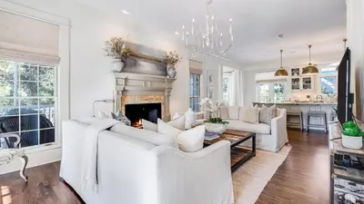 a living room with white furniture and a fireplace at Southern Breeze in Inlet Beach