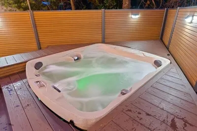 a jacuzzi tub sitting on top of a wooden deck at Sandcastle House Hot Tub, OD Kitchen & Game Room! in Panama City Beach