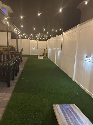 a baseball field with green grass and lights on it at Vibrant NewOrleans style retreat in Panama City Beach