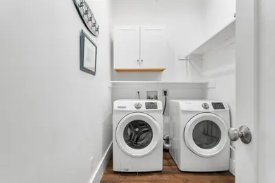 a laundry room with a washer and a washing machine at Breezin at 19406 FBR in Panama City Beach