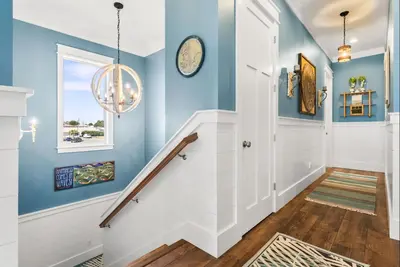 a staircase in a home with blue walls at Breezin at 19406 FBR in Panama City Beach