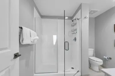 a white bathroom with a shower and a toilet at Calypso 3-1107 in Panama City Beach