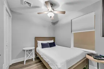 a bedroom with a bed with a ceiling fan at Calypso 3-1107 in Panama City Beach