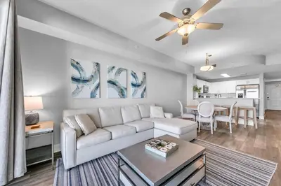 a living room with a couch and a table at Calypso 3-1107 in Panama City Beach