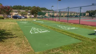a tennis court with white markings on the grass at 2 BD 2 and half BA Two Story Beach Haven Pet Friendly with Golf Cart in Panama City Beach