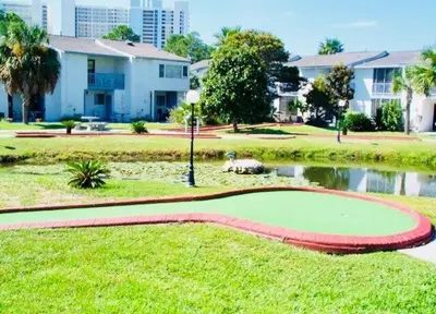 a golf course in a park with a pond at 2 BD 2 and half BA Two Story Beach Haven Pet Friendly with Golf Cart in Panama City Beach
