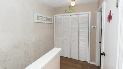 a bathroom with a closet and a white door at 2 BD 2 and half BA Two Story Beach Haven Pet Friendly with Golf Cart in Panama City Beach