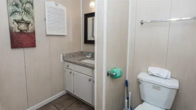 a bathroom with a toilet and a sink at 2 BD 2 and half BA Two Story Beach Haven Pet Friendly with Golf Cart in Panama City Beach
