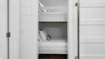 a bedroom with white walls and a bunk bed at Best of Both Worlds in Santa Rosa Beach