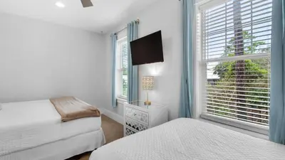 a bedroom with two beds and a window at Best of Both Worlds in Santa Rosa Beach