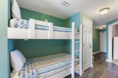 a bedroom with two bunk beds in a room at 1004 Seychelles in Panama City Beach