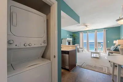 a kitchen and living room with a view of the ocean at 1004 Seychelles in Panama City Beach