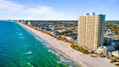 an aerial view of a beach and a tall building at 1004 Seychelles in Panama City Beach