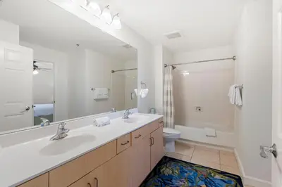 a bathroom with two sinks and a shower and a toilet at 1005 Sterling Beach in Panama City Beach