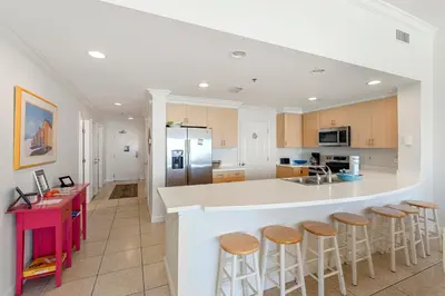 a kitchen with a large island with bar stools at 1005 Sterling Beach in Panama City Beach