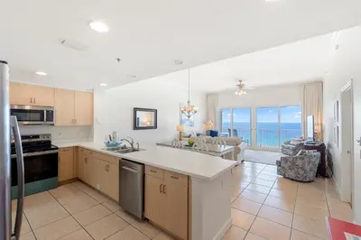 a large kitchen with a view of the ocean at 1005 Sterling Beach in Panama City Beach