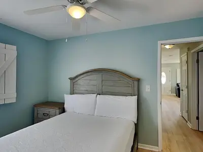 a bedroom with a white bed and a ceiling fan at PC Beach Retreat D in Panama City Beach
