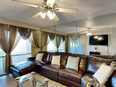a brown leather couch in a living room with a ceiling fan at Edgewater Villa #2005 in Panama City Beach