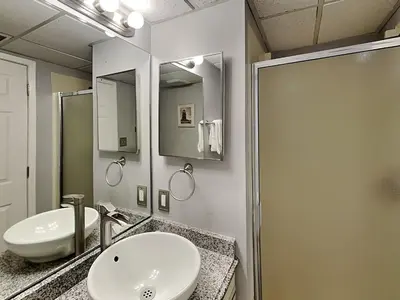 a bathroom with two sinks and a shower at Edgewater Villa #2005 in Panama City Beach