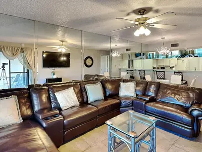 a living room with a leather couch and a table at Edgewater Villa #2005 in Panama City Beach