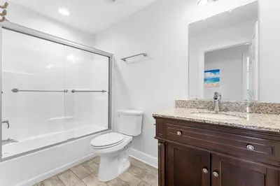 a bathroom with a toilet and a shower and a sink at Beach House - Sunset Escape by Panhandle Getaways in Panama City Beach