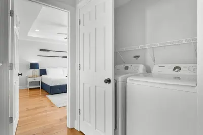 a white laundry room with a washer and dryer at Beach House - Sunset Escape by Panhandle Getaways in Panama City Beach