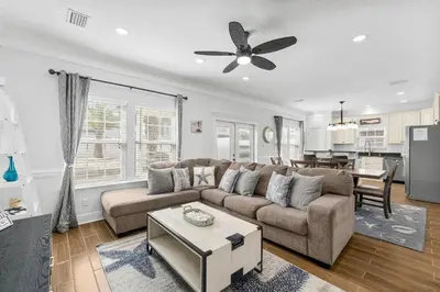 a living room with a couch and a table at Beach House - Sunset Escape by Panhandle Getaways in Panama City Beach