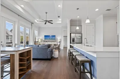 a kitchen and living room with a couch and a table at The Anchorage in Inlet Beach