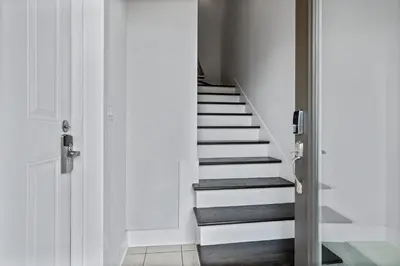 a stairway with white walls and white stairs at The Anchorage in Inlet Beach