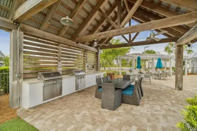a patio with a grill and a table and chairs at The Anchorage in Inlet Beach