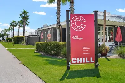 a red sign in the grass next to a sidewalk at The Anchorage in Inlet Beach